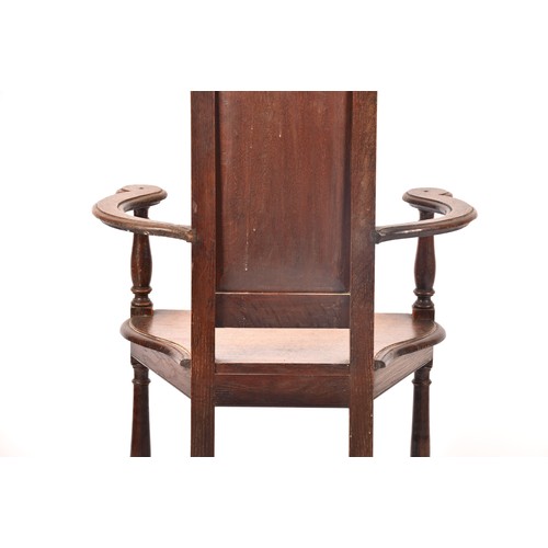 291 - An 19th century carved oak armchair, the back carved with the bust of the green man, above a panel c... 