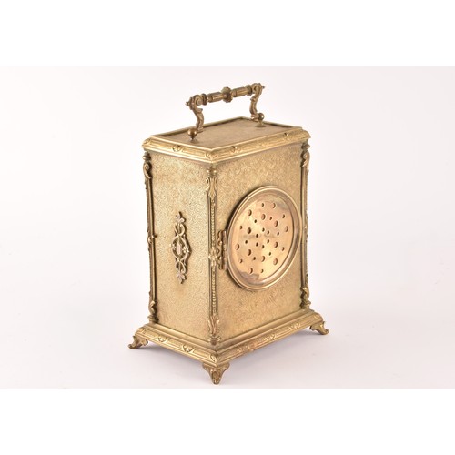 275 - A 19th century French brass mantel clock, with ornate relief decoration and engraved detail, the whi... 