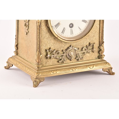 275 - A 19th century French brass mantel clock, with ornate relief decoration and engraved detail, the whi... 