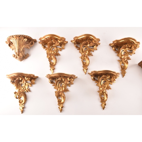 253 - A group of eight carved gilt sconces, largest measuring 22.5 cm height x 20 cm width, six sconces me... 