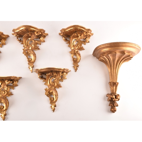 253 - A group of eight carved gilt sconces, largest measuring 22.5 cm height x 20 cm width, six sconces me... 