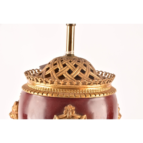 254 - A 19th century French Ormolu table lamp, the oxblood red painted enamel with gilt lion decoration on... 