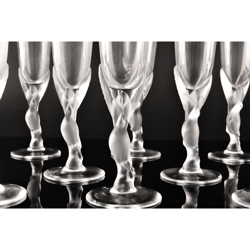 226 - A set of twelve Igor Carl Fabergé crystal champagne flutes, the frosted stems modelled as two kissin... 