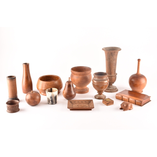 256 - A collection of assorted carved wooden treen items, including vases, cups, bowls, carved fruit, a ca... 