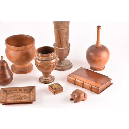 256 - A collection of assorted carved wooden treen items, including vases, cups, bowls, carved fruit, a ca... 