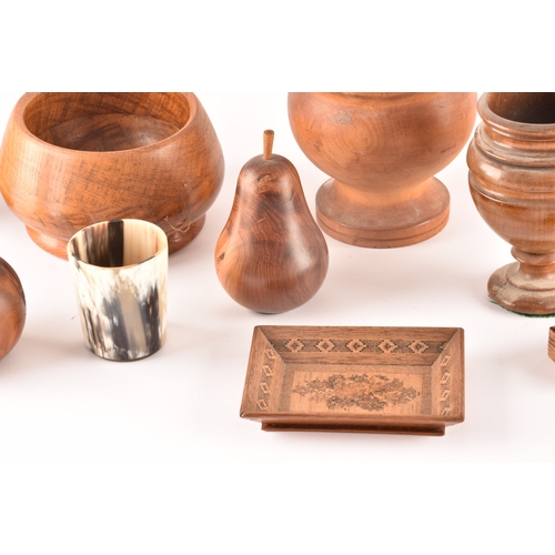 256 - A collection of assorted carved wooden treen items, including vases, cups, bowls, carved fruit, a ca... 