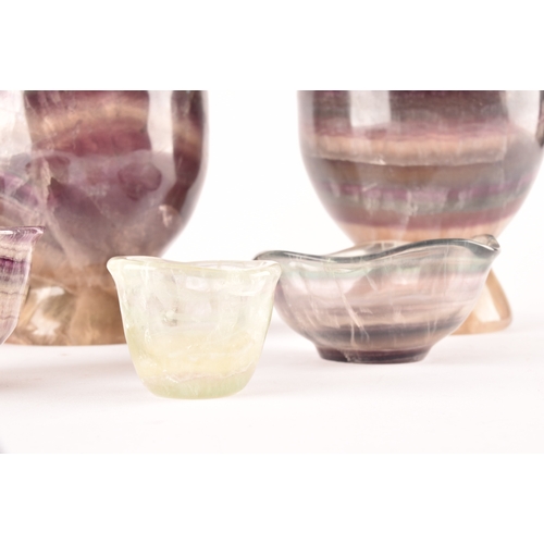 257 - Two carved fluorite urns, one 14 cm high, the other 13 cm high, together with a small collection of ... 