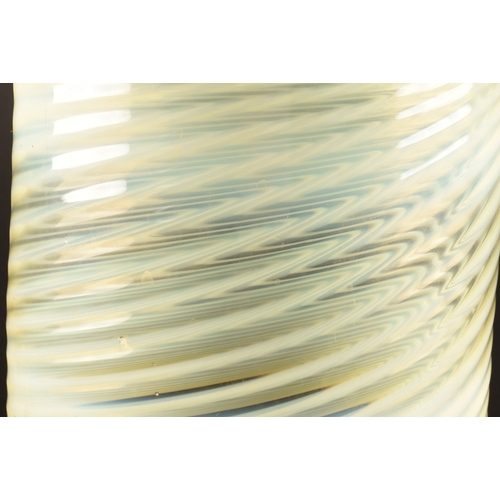 231 - A large opalescent pale green glass light shade, with swirled and ribbed detail, 22 cm high x 18.5 c... 