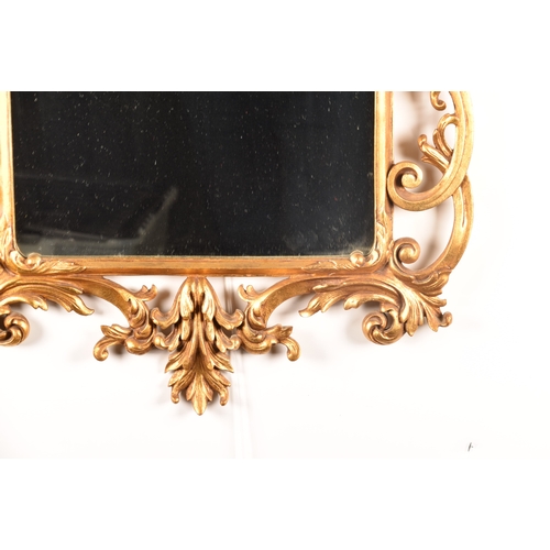 296 - A decorative gilt gesso framed wall mirror with ornately scrolled and floral frame, and original gla... 