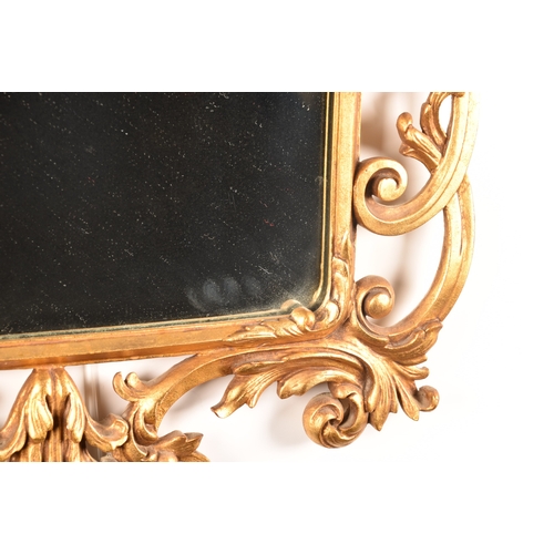 296 - A decorative gilt gesso framed wall mirror with ornately scrolled and floral frame, and original gla... 