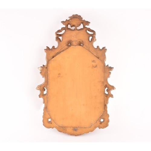 297 - An 18th Century gilt and painted wall mirror, the framed carved, painted and gilded with scrolls, an... 