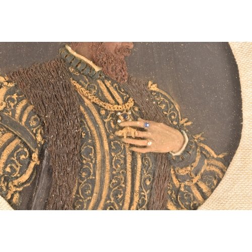 258 - An early 20th century carved and painted wax portrait of a Tudor nobleman, in richly decorated robes... 