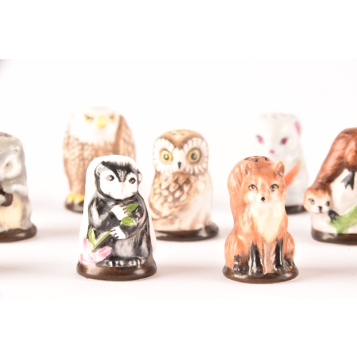 263 - A collection of 'Friends of the Forest' thimbles, including fifteen animal thimbles, accompanied by ... 