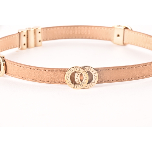 13 - Bulgari. A tan leather double coiled wrap bracelet with gold tone hardware, the interlocking rings f... 