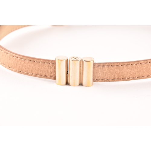 13 - Bulgari. A tan leather double coiled wrap bracelet with gold tone hardware, the interlocking rings f... 