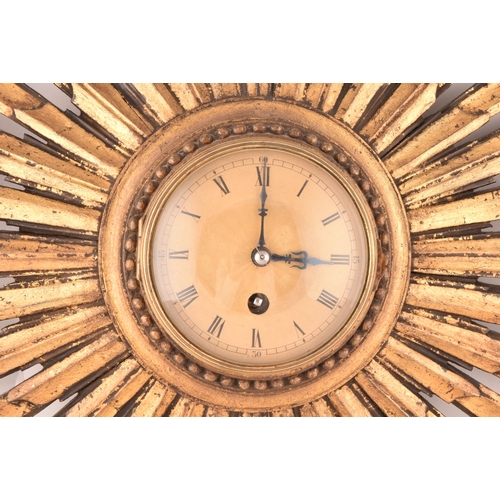 277 - An Art Deco starburst wall clock, with gold roman numeral dial, gilt wood, 55cm wide x 41 cm high.