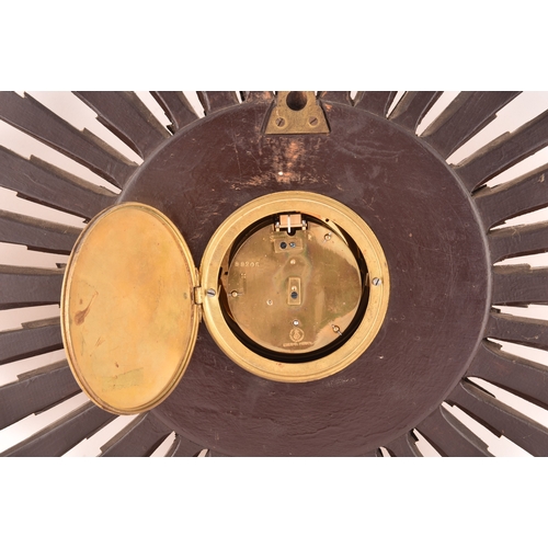 277 - An Art Deco starburst wall clock, with gold roman numeral dial, gilt wood, 55cm wide x 41 cm high.