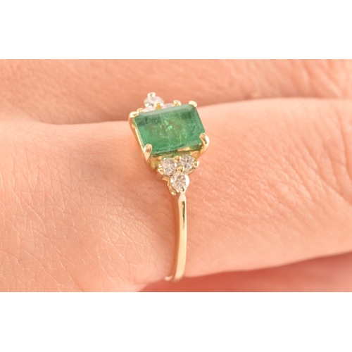 17 - An 18ct yellow gold ring, featuring an rectangular emerald with an approximate weight of 1.10 carats... 