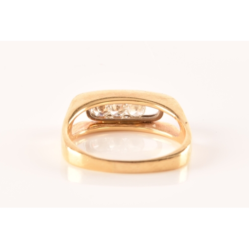 20 - An 18ct yellow gold diamond three stone ring, set to centre with three round brilliant cut diamonds ... 