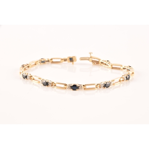 71 - A 14ct yellow gold sapphire and diamond line bracelet, set with ten oval cut sapphires with an appro... 