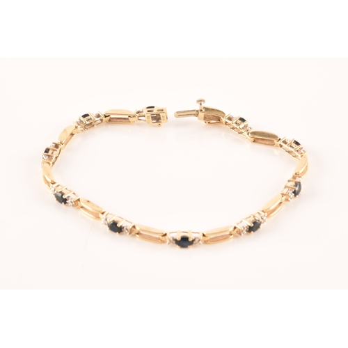 71 - A 14ct yellow gold sapphire and diamond line bracelet, set with ten oval cut sapphires with an appro... 