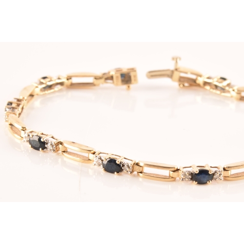 71 - A 14ct yellow gold sapphire and diamond line bracelet, set with ten oval cut sapphires with an appro... 