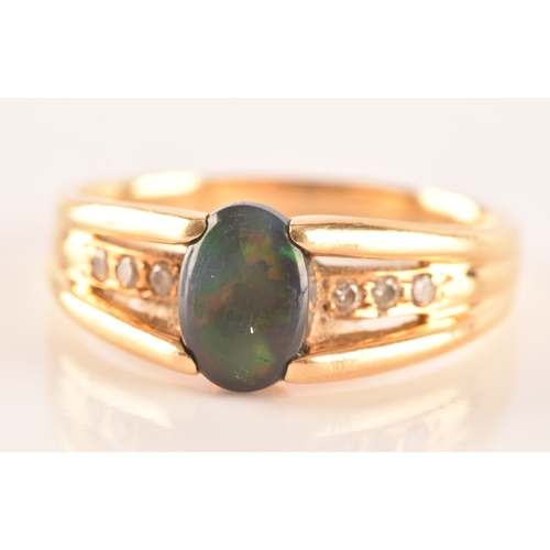 79 - A 18ct yellow gold ring, set to centre with a lightning ridge black opal doublet measuring L 8 x W 5... 