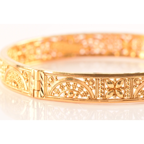 2 - A 22ct yellow gold bangle, with ornate filigree detail, marked 'SIR22K', 6cm diameter.