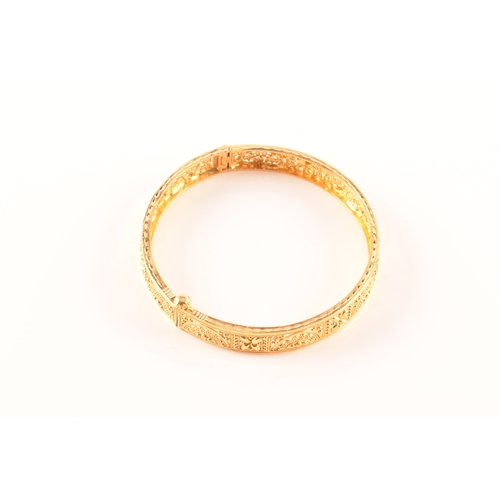 2 - A 22ct yellow gold bangle, with ornate filigree detail, marked 'SIR22K', 6cm diameter.