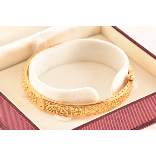 2 - A 22ct yellow gold bangle, with ornate filigree detail, marked 'SIR22K', 6cm diameter.