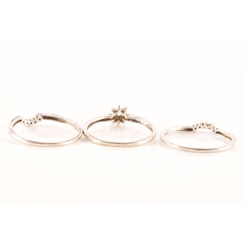 28 - A set of three 9ct white gold and diamond rings, to include a floral ring set with seven round brill... 