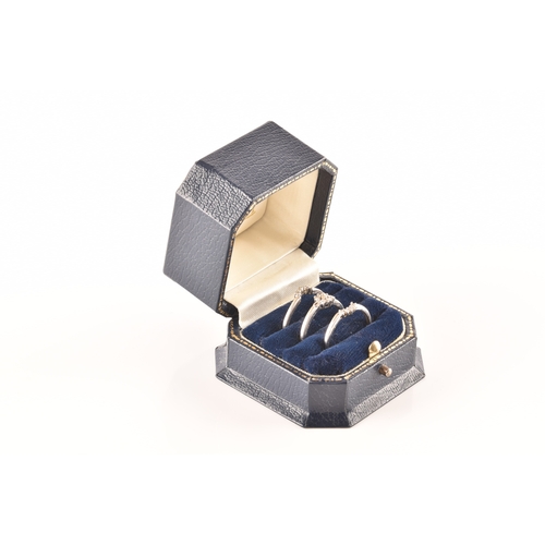 28 - A set of three 9ct white gold and diamond rings, to include a floral ring set with seven round brill... 