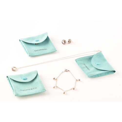 31 - Tiffany & Co. A group of Perreti design jewellery, to include a silver teardrop bean chain brace... 