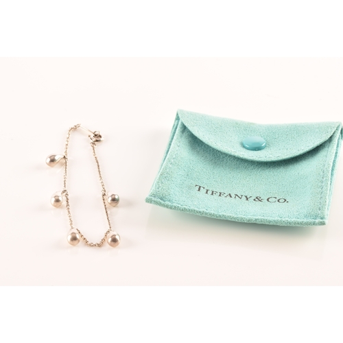 31 - Tiffany & Co. A group of Perreti design jewellery, to include a silver teardrop bean chain brace... 