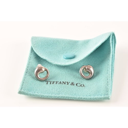 31 - Tiffany & Co. A group of Perreti design jewellery, to include a silver teardrop bean chain brace... 