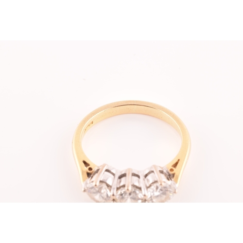 11 - A three stone 18ct yellow and white metal diamond ring, set with three round brilliant cut diamonds ... 