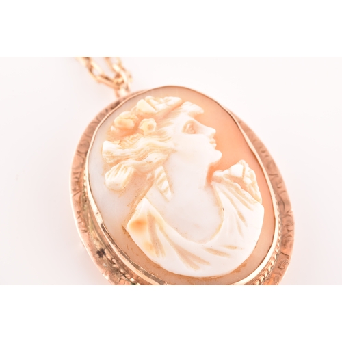 32 - A Cameo rose metal pendant/brooch on a 9ct gold chain, pendant length 3.5cm, chain length 60 cm.