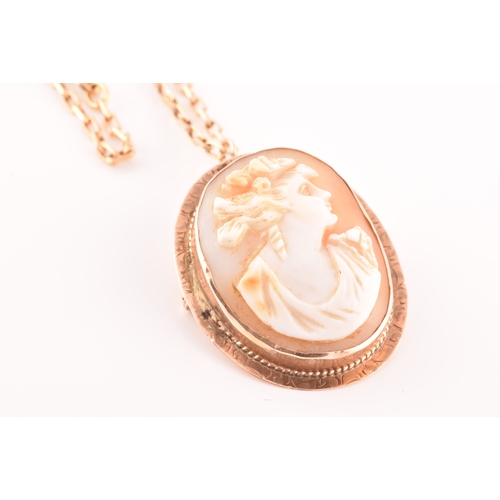 32 - A Cameo rose metal pendant/brooch on a 9ct gold chain, pendant length 3.5cm, chain length 60 cm.