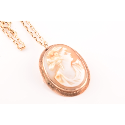 32 - A Cameo rose metal pendant/brooch on a 9ct gold chain, pendant length 3.5cm, chain length 60 cm.