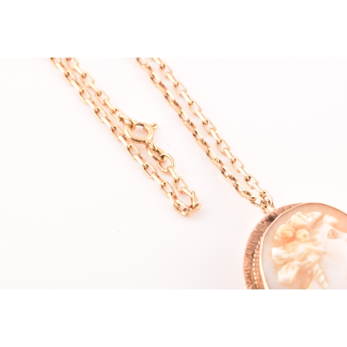 32 - A Cameo rose metal pendant/brooch on a 9ct gold chain, pendant length 3.5cm, chain length 60 cm.