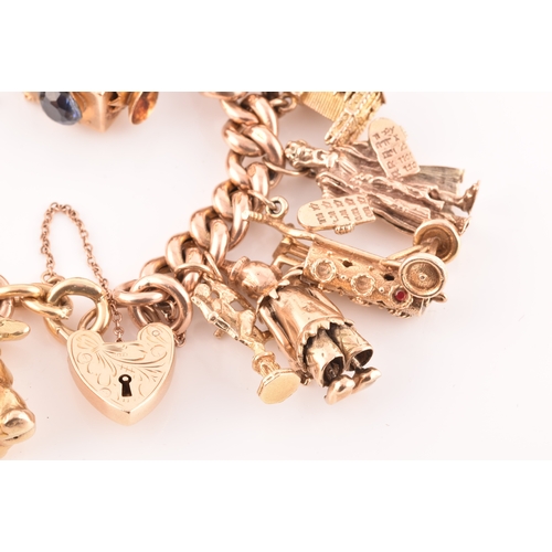 1 - A 9ct rose gold curb link charm bracelet, suspended with a vast collection of 9ct yellow gold charms... 