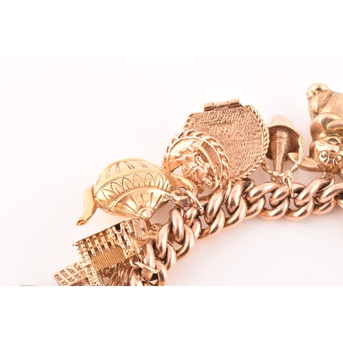 1 - A 9ct rose gold curb link charm bracelet, suspended with a vast collection of 9ct yellow gold charms... 