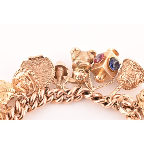 1 - A 9ct rose gold curb link charm bracelet, suspended with a vast collection of 9ct yellow gold charms... 