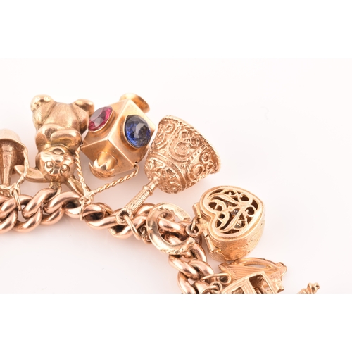 1 - A 9ct rose gold curb link charm bracelet, suspended with a vast collection of 9ct yellow gold charms... 