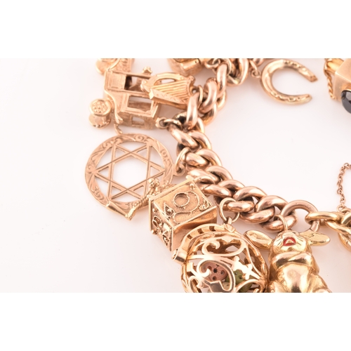 1 - A 9ct rose gold curb link charm bracelet, suspended with a vast collection of 9ct yellow gold charms... 