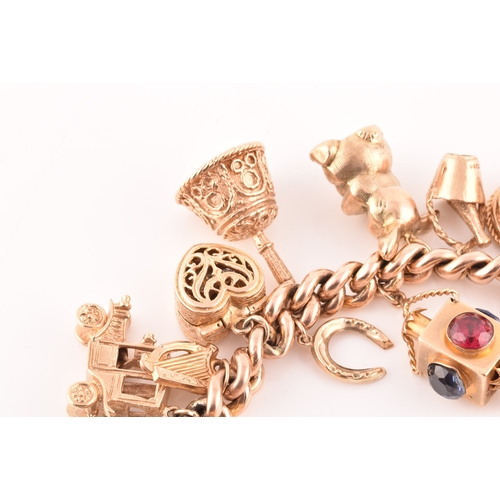 1 - A 9ct rose gold curb link charm bracelet, suspended with a vast collection of 9ct yellow gold charms... 