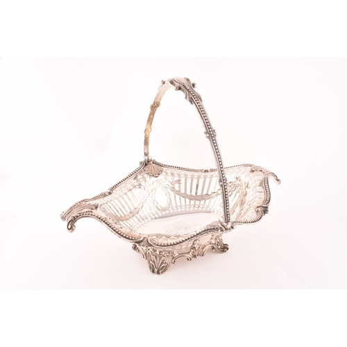 122 - A Victorian silver pierced footed basket with swing handle, hallmarked Birmingham 1859 by Elkington ... 