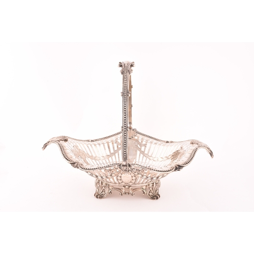 122 - A Victorian silver pierced footed basket with swing handle, hallmarked Birmingham 1859 by Elkington ... 