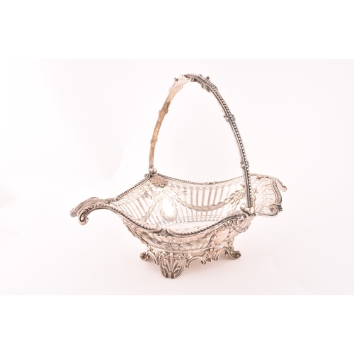 122 - A Victorian silver pierced footed basket with swing handle, hallmarked Birmingham 1859 by Elkington ... 