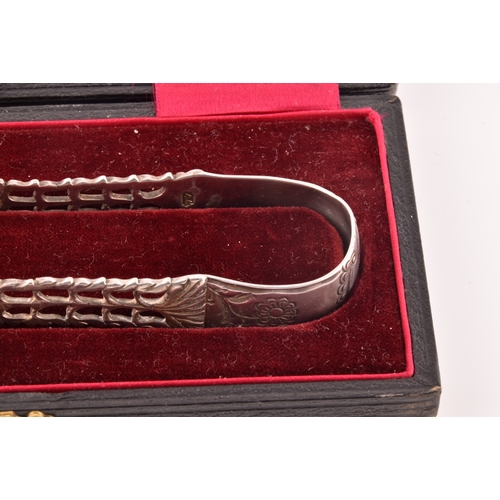 135 - A pair of Georgian cast silver sugar tongs, by Richard Mills, crest engraved, featuring floral  deco... 